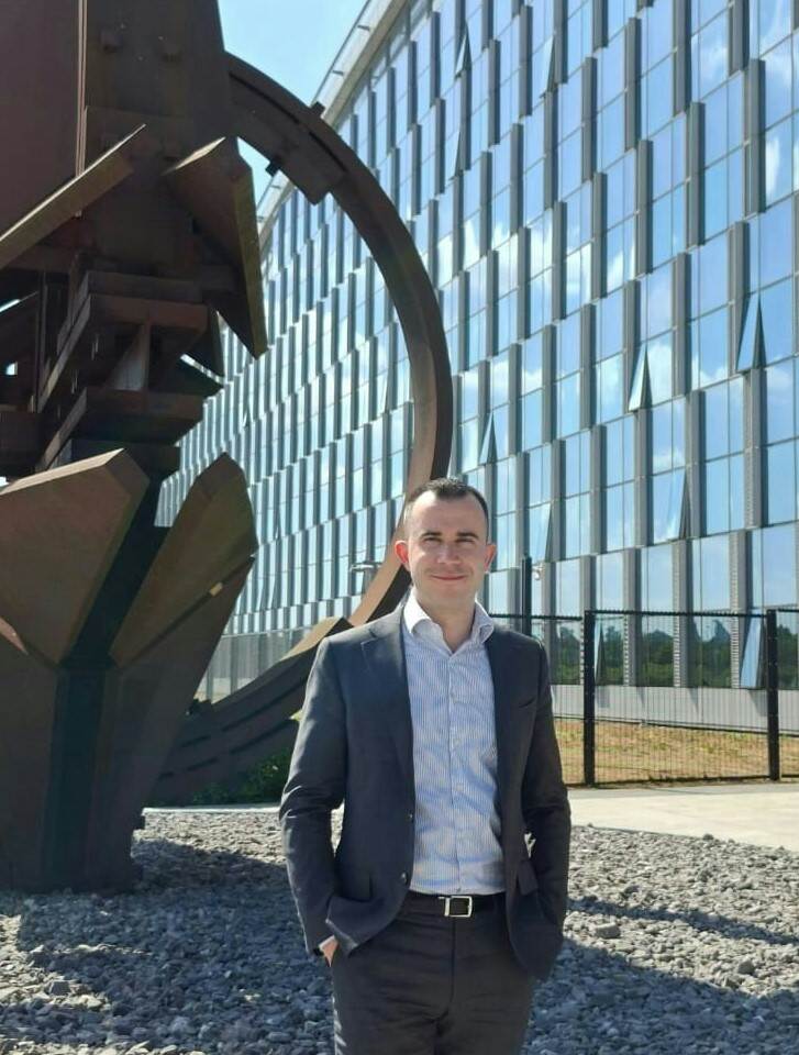 NAVO-medewerker Mike staat voor een kantoorgebouw